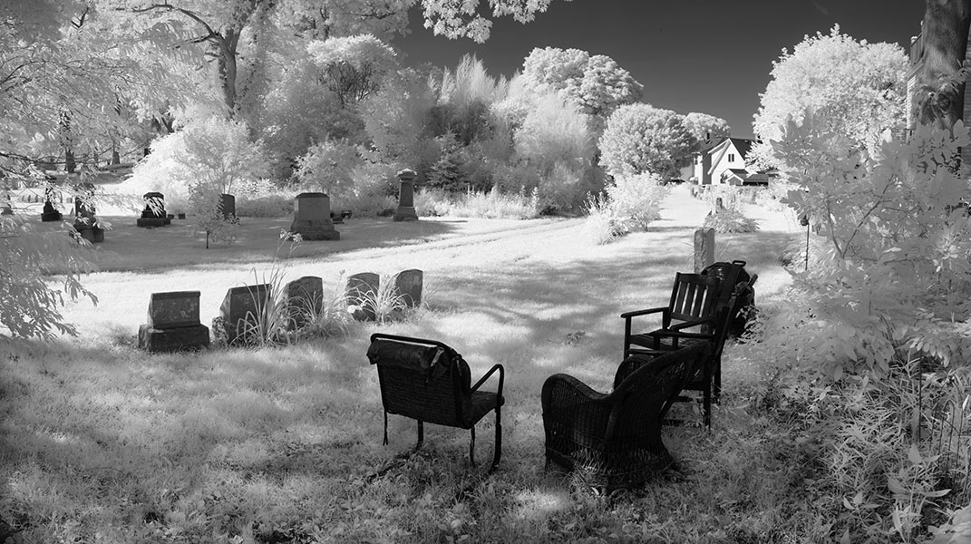 Infrared Panoramic Photo of Chairs Set UP in Cemetery.